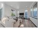 Bright living room featuring hardwood floors, large windows, and stylish decor at 6047 N Nepal Ct, Aurora, CO 80019
