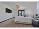 Bright main bedroom featuring a king bed, mounted TV, and comfortable decor at 6047 N Nepal Ct, Aurora, CO 80019