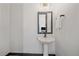 Stylish powder room with a pedestal sink and modern fixtures at 6047 N Nepal Ct, Aurora, CO 80019