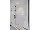 Modern glass-enclosed shower with sleek tile and a built-in bench at 6047 N Nepal Ct, Aurora, CO 80019