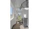 A well-lit staircase leads to upper floors, showcasing modern railings and views of a community park at 6047 N Nepal Ct, Aurora, CO 80019