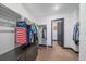 Spacious walk-in closet with ample hanging space, and built-in drawers for organized storage at 6047 N Nepal Ct, Aurora, CO 80019