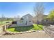 Fenced backyard with lawn, patio, stone pavers, and mature trees, ideal for outdoor living at 2905 E Yarrow Cir, Superior, CO 80027
