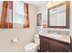 Bathroom features a granite countertop, dark wood vanity, and decorative mirror at 2905 E Yarrow Cir, Superior, CO 80027
