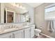Modern bathroom with double sinks, mosaic tile backsplash, and wood-style floors at 2905 E Yarrow Cir, Superior, CO 80027