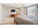 Bedroom with carpeting, a gray comforter, flat screen TV, and closet at 2905 E Yarrow Cir, Superior, CO 80027