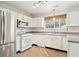 Well-lit kitchen features white cabinets, stainless steel appliances, and a window with lovely outdoor views at 2905 E Yarrow Cir, Superior, CO 80027