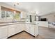 Bright kitchen with wood floors and a view into the adjacent living room at 2905 E Yarrow Cir, Superior, CO 80027