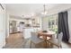 Eat-in kitchen with white cabinets, stainless steel appliances, and access to the backyard at 2905 E Yarrow Cir, Superior, CO 80027