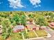 Aerial view of a neighborhood with mature trees and well-kept lawns, close to local amenities and community parks at 1600 Xanthia St, Denver, CO 80220