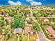 Aerial view of a tranquil neighborhood with tree-lined streets, showcasing homes with well-manicured lawns and gardens at 1600 Xanthia St, Denver, CO 80220