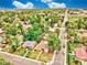 Aerial view of a residential neighborhood with tree-lined streets, showcasing homes with well-maintained yards and gardens at 1600 Xanthia St, Denver, CO 80220