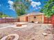 A fully fenced backyard featuring a fire pit and a small patio at 1600 Xanthia St, Denver, CO 80220