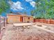 Fully fenced backyard with fire pit and concrete patio outside the back door at 1600 Xanthia St, Denver, CO 80220