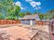 Cozy backyard with a concrete patio, fire pit, detached garage and privacy fence at 1600 Xanthia St, Denver, CO 80220