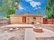 Fully fenced yard, featuring patio and fire pit, perfect for outdoor entertaining at 1600 Xanthia St, Denver, CO 80220