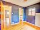 Bedroom featuring dark blue walls, hardwood floors, and a closet, offering cozy space at 1600 Xanthia St, Denver, CO 80220