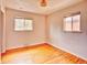 Bedroom with hardwood floors and two windows, offering natural light and a clean space at 1600 Xanthia St, Denver, CO 80220