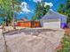 Spacious driveway leading to a detached garage and fenced backyard for privacy at 1600 Xanthia St, Denver, CO 80220