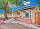 Side view of a brick home, showcasing a bay window and well-maintained landscaping at 1600 Xanthia St, Denver, CO 80220