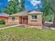Charming brick home with a well-maintained lawn and mature trees at 1600 Xanthia St, Denver, CO 80220