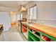 Bright kitchen featuring open shelving, wood countertops, updated appliances, and new floors at 1600 Xanthia St, Denver, CO 80220