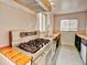 Close-up of a well-lit kitchen featuring stainless steel appliances and decorative countertops at 1600 Xanthia St, Denver, CO 80220