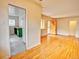 Spacious living room featuring refinished hardwood floors and seamless flow into kitchen at 1600 Xanthia St, Denver, CO 80220