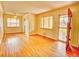 Sunny living room with hardwood floors, multiple windows, and stylish front door at 1600 Xanthia St, Denver, CO 80220