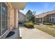 Backyard brick patio area with nearby landscaping and a view of the exterior of neighboring homes at 7700 W Grant Ranch Blvd # 7C, Littleton, CO 80123