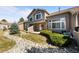 Rear exterior view of home with backyard patio, landscaping, and stone rock garden at 7700 W Grant Ranch Blvd # 7C, Littleton, CO 80123