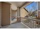 Cozy covered porch featuring concrete flooring, decorative lanterns and brick columns at 7700 W Grant Ranch Blvd # 7C, Littleton, CO 80123