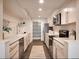 Modern kitchen with white cabinets, quartz countertops, and stainless steel appliances at 99 S Downing St # B2, Denver, CO 80209