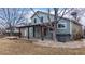 Exterior of home featuring large covered patio, hot tub, and landscaping at 12861 Royal Ct, Broomfield, CO 80020