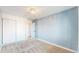 Bedroom featuring plush carpet, closet with paneled doors, and modern light fixture at 12861 Royal Ct, Broomfield, CO 80020