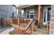 Inviting front porch with wooden railings, brick accents, and a cozy seating area at 12861 Royal Ct, Broomfield, CO 80020