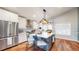 Well-equipped kitchen featuring a center island, stainless steel appliances and hardwood flooring at 12861 Royal Ct, Broomfield, CO 80020