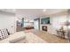 Spacious living room with a fireplace and seamless transition to the modern kitchen at 12861 Royal Ct, Broomfield, CO 80020