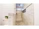 Close up of a shower with marble tile and stone floor at 12861 Royal Ct, Broomfield, CO 80020