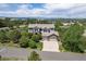 Stunning aerial view of home, surrounded by mature trees, nestled in a picturesque neighborhood with mountain views at 6299 Ellingwood Point Pl, Castle Rock, CO 80108