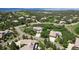 An aerial view of a neighborhood full of well maintained homes surrounded by lush green trees at 6299 Ellingwood Point Pl, Castle Rock, CO 80108