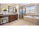 Bathroom featuring a glass-enclosed shower, a bathtub, and a vanity with drawers at 6299 Ellingwood Point Pl, Castle Rock, CO 80108
