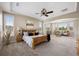 Bright bedroom featuring a spacious seating area, large windows, and tray ceilings at 6299 Ellingwood Point Pl, Castle Rock, CO 80108