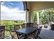 Covered patio features comfortable seating and scenic views, perfect for outdoor dining at 6299 Ellingwood Point Pl, Castle Rock, CO 80108