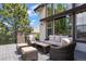 Relaxing covered patio with comfortable seating and a view of lush trees, ideal for outdoor living at 6299 Ellingwood Point Pl, Castle Rock, CO 80108