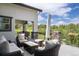 Inviting covered patio featuring comfortable seating and a beautiful view, perfect for relaxation and entertaining at 6299 Ellingwood Point Pl, Castle Rock, CO 80108