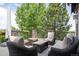 Cozy covered patio with comfortable seating surrounded by lush trees for private outdoor relaxation at 6299 Ellingwood Point Pl, Castle Rock, CO 80108