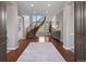 Elegant foyer featuring a curved staircase, hardwood floors, and ample natural light at 6299 Ellingwood Point Pl, Castle Rock, CO 80108