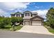 Charming two-story home with a three-car garage and well-manicured lawn, perfect for suburban living at 6299 Ellingwood Point Pl, Castle Rock, CO 80108