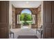 Inviting front porch framed by stone archways and columns, offering a tranquil outdoor space at 6299 Ellingwood Point Pl, Castle Rock, CO 80108